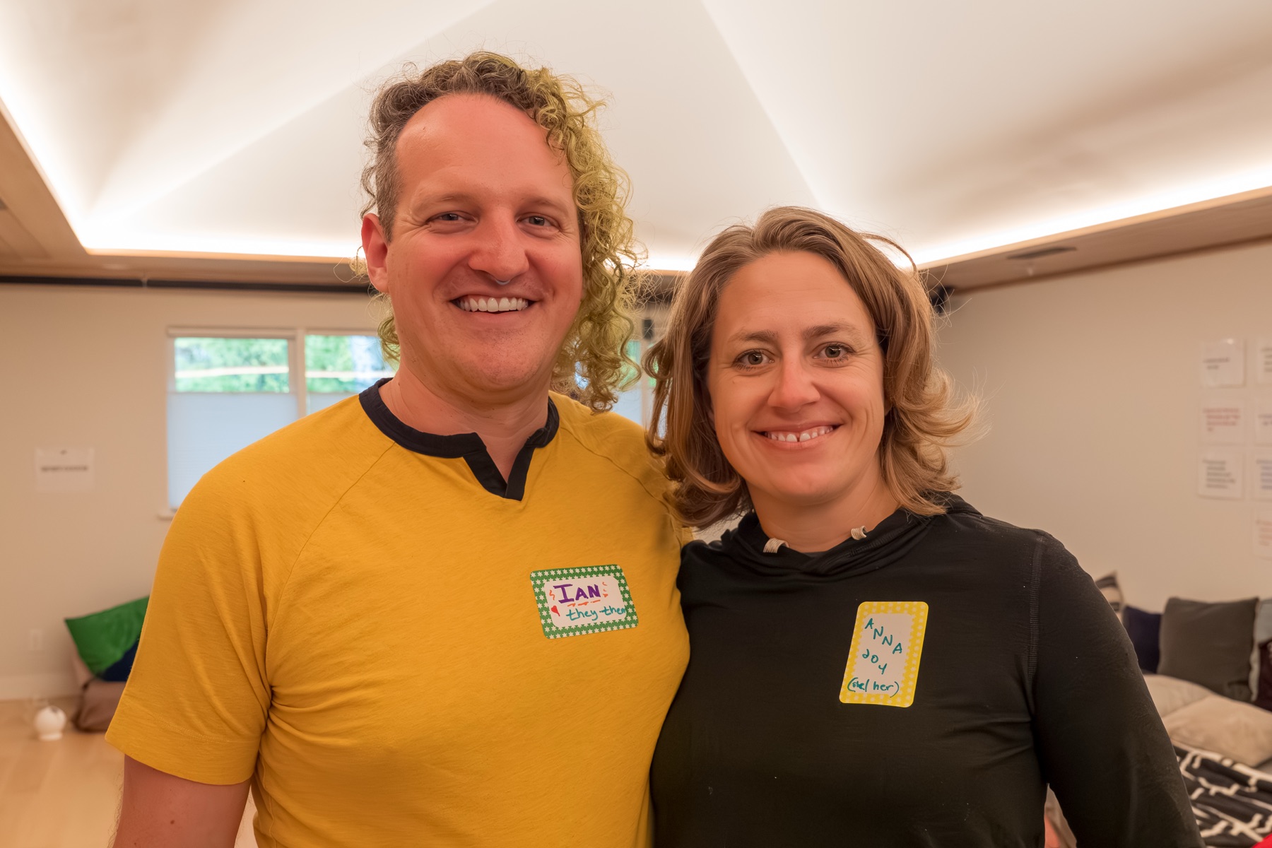 Ian Wilson and Anna Joy Reedy smiling together and wearing handwritten name tags